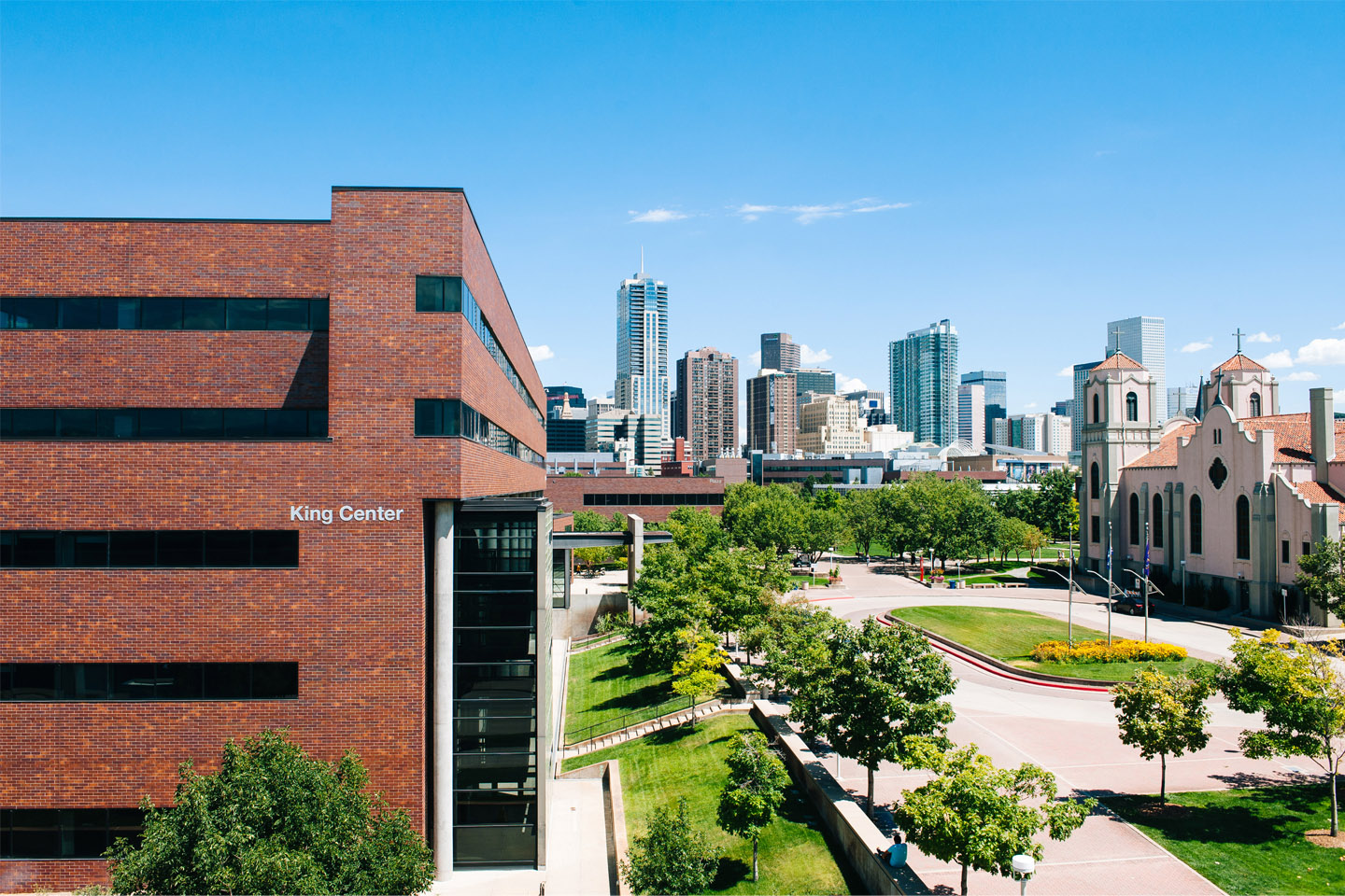 King Center building with Auraria Campus in foreground and skyline of Denver in background