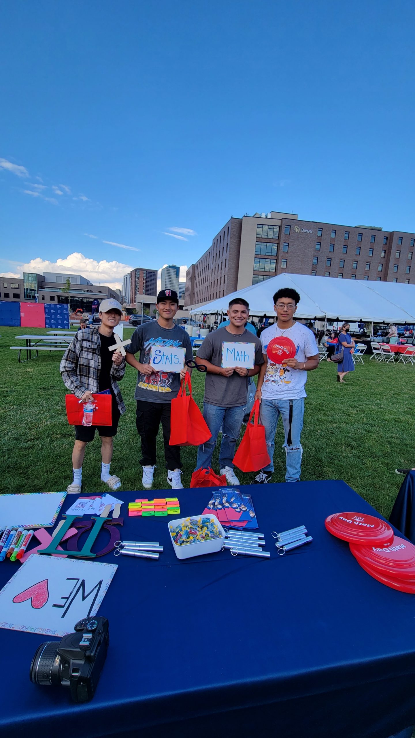 Math and Stats students having fun at an outdoor event holding