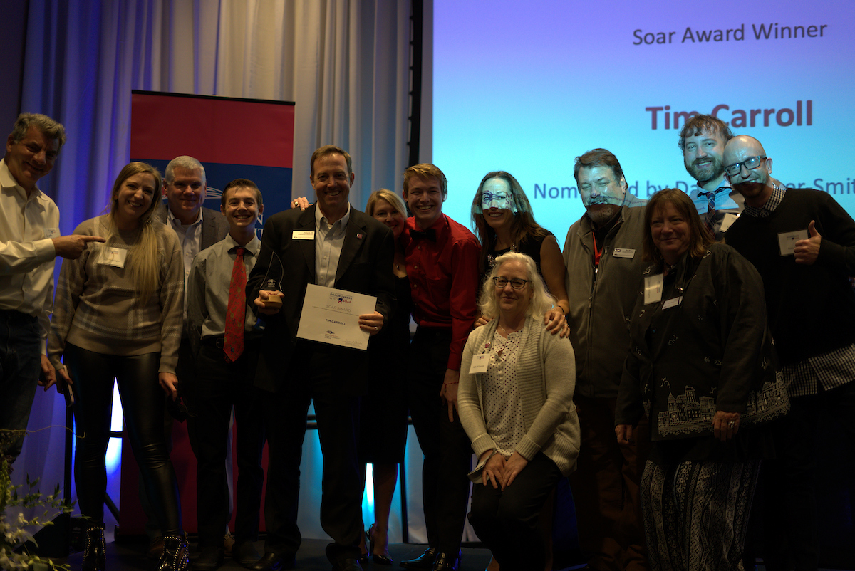 Soar Award winner Tim Carroll poses withfamily and team members at 2021 Roadrunners Who Soar Awards ceremony.