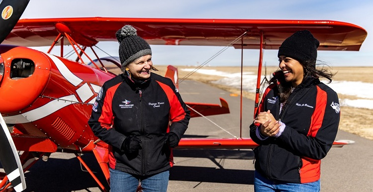 Dagmar Kress, lecturer and aerobatics team coach and MSU Denver student, Haley Jo Brinson, in front of a plane.