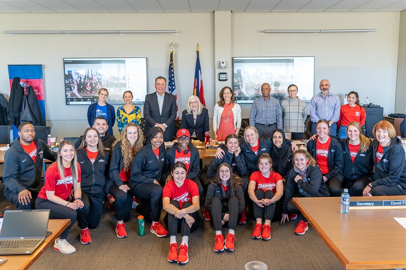 MSU Denver trustees pose with women's basketball team and coaches.
