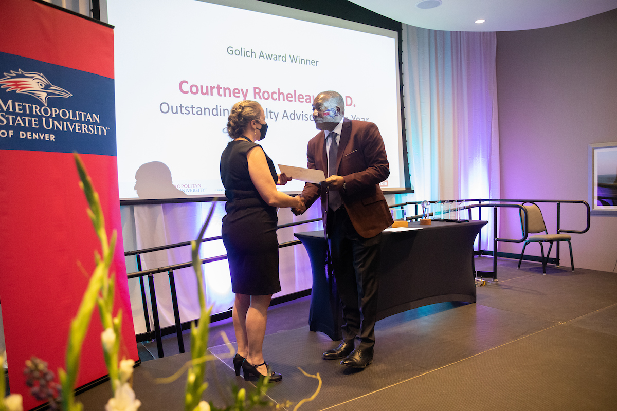 Outstanding Faculty Advisor Award winner Courtney Rocheleau, Ph.D., accepts award from Provost Alfred Tatum, Ph.D.,
