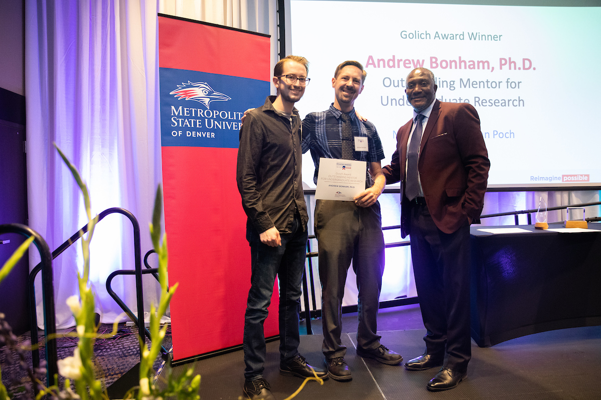 Outstanding Mentor for Undergraduate Research Award winner Andrew Bonham, Ph.D., poses with student and Provost Alfred Tatum, Ph.D., at 2021 Roadrunners Who Soar Awards ceremony.