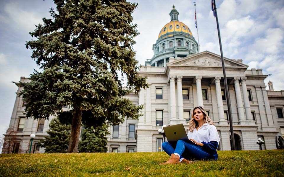 Online student studying outside Denver capitol