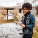 Online student studying outdoors