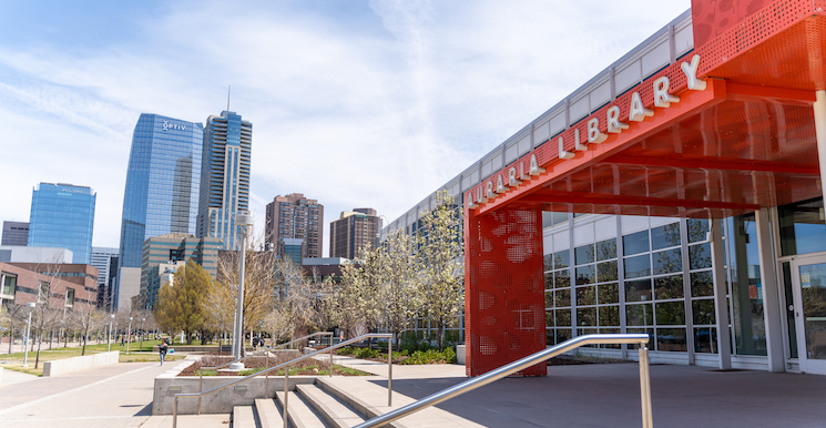 Exterior of Auraria Library with downtown Denver in the background.