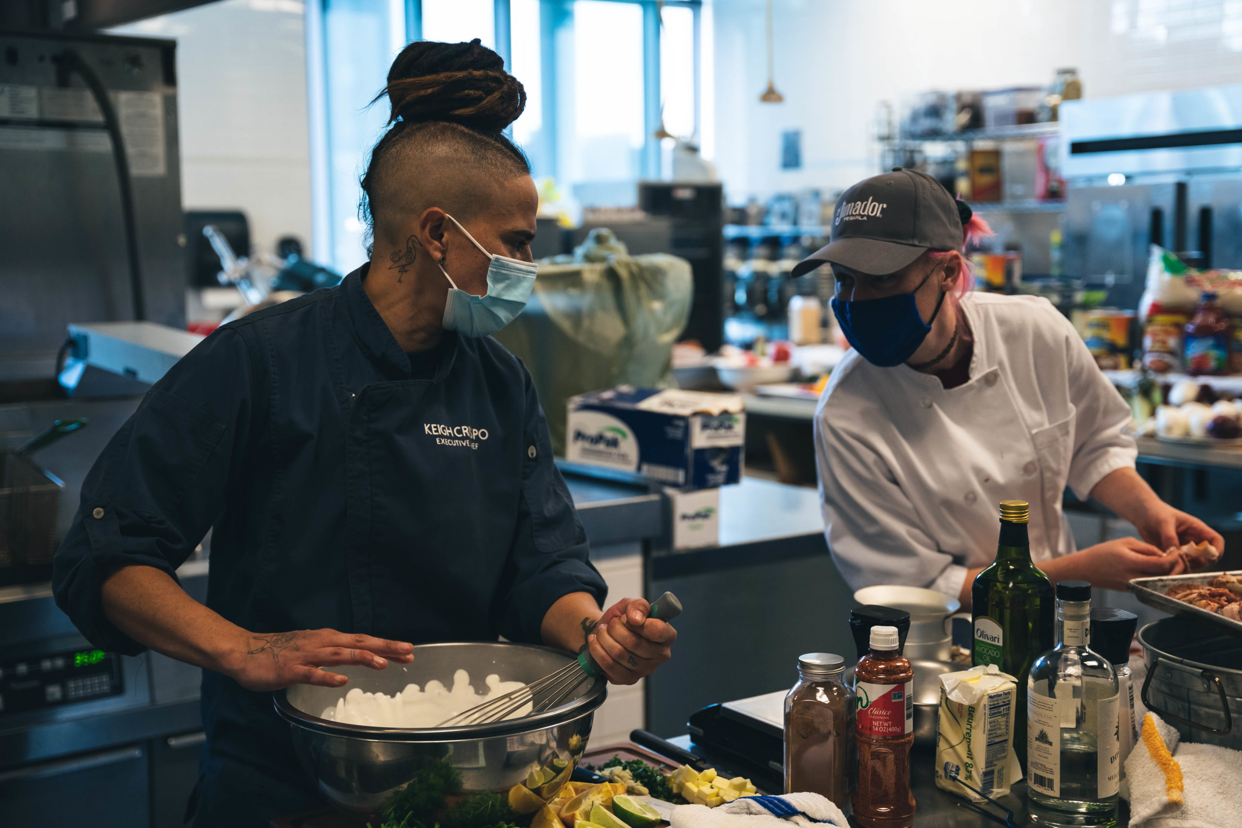 A student and chef prepare food for the Hispanic Restaurant Top Chef 2021 Competition