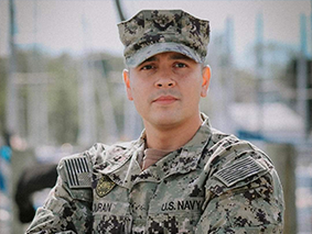 Leon Duran standing in his U.S. Navy uniform.