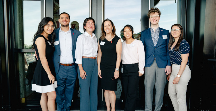 Janine Davidson, Ph.D., posed with the first six students interning in public service at Mi Vida Restaurant in Washington, DC.