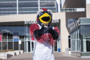MSU Denver mascot, Rowdy giving a double thumbs-up in front of JSSB.