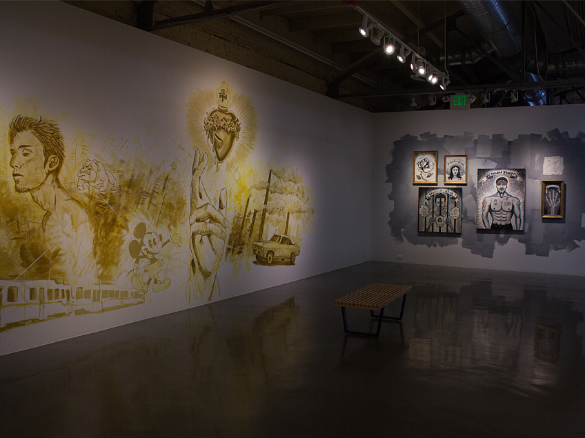 Art gallery with a mural and framed artworks on adjacent walls, featuring diverse illustrations and portraits.