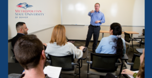 MSU Denver logo overlaid on photo of instructor pointing towards classroom full of students.