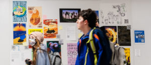 Students between classes walk through the hallways and pass by artworks posted on the bulletin boards.