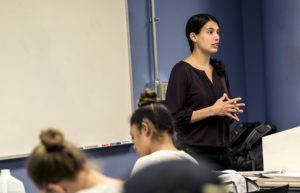 Emily Ragan, Ph.D., teaching in front of class.