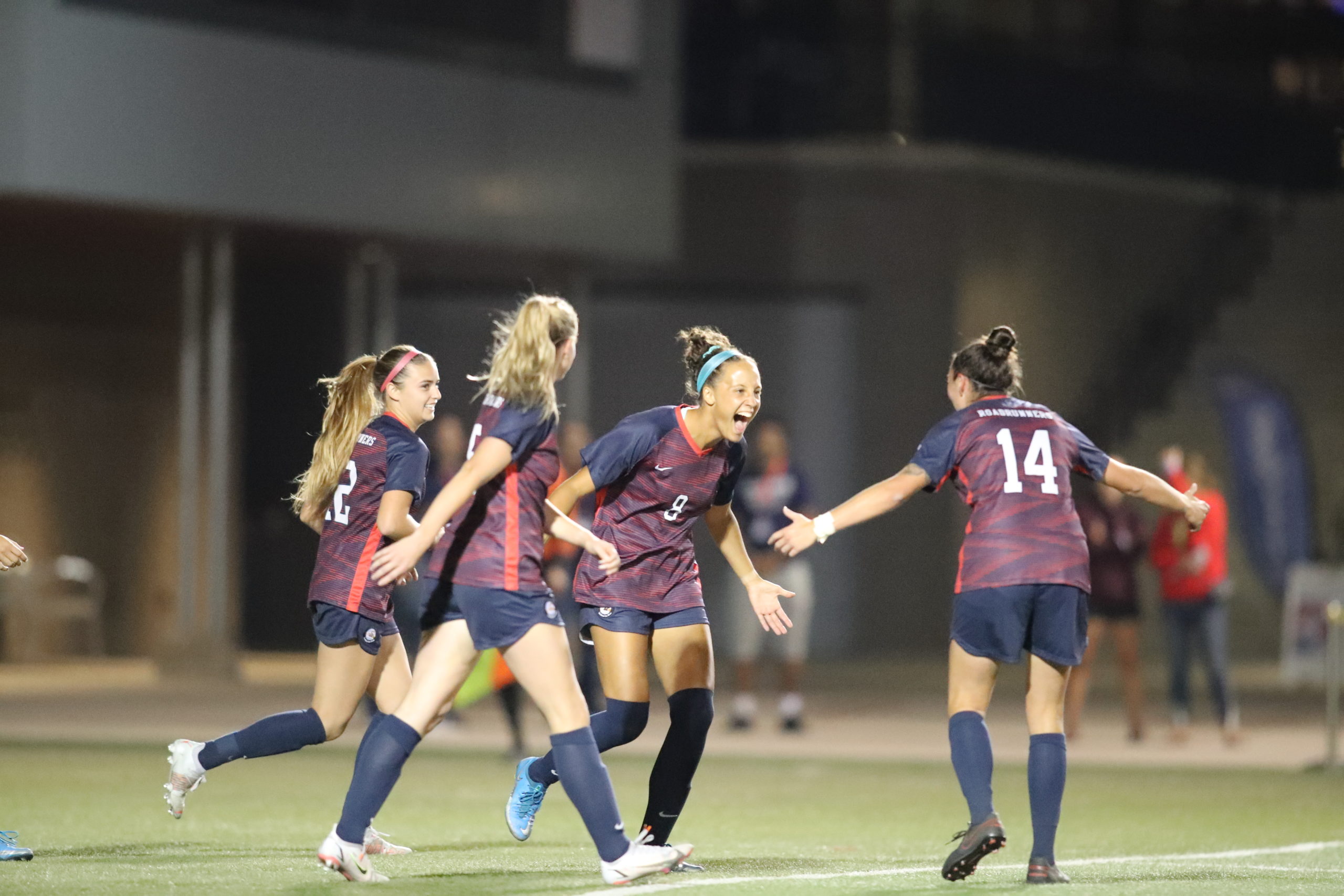 Women's soccer player Elisa Dean celebrates a goal during a night game in 2021.