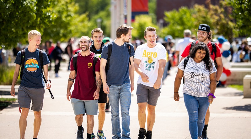 Smiling students walking in a group