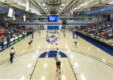Auraria Events Center during a volleyball match in 2021, with a view from the endline, facing the videoboard..