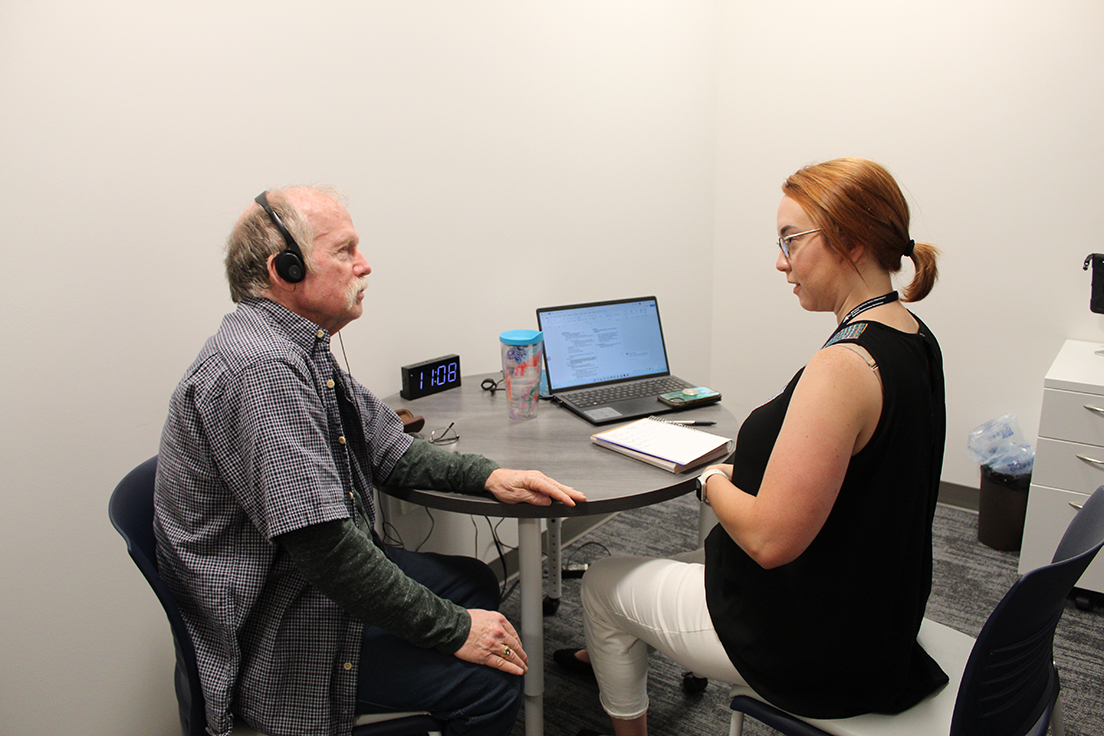 Graduate MS SLP student (right) working with an older adult (left)