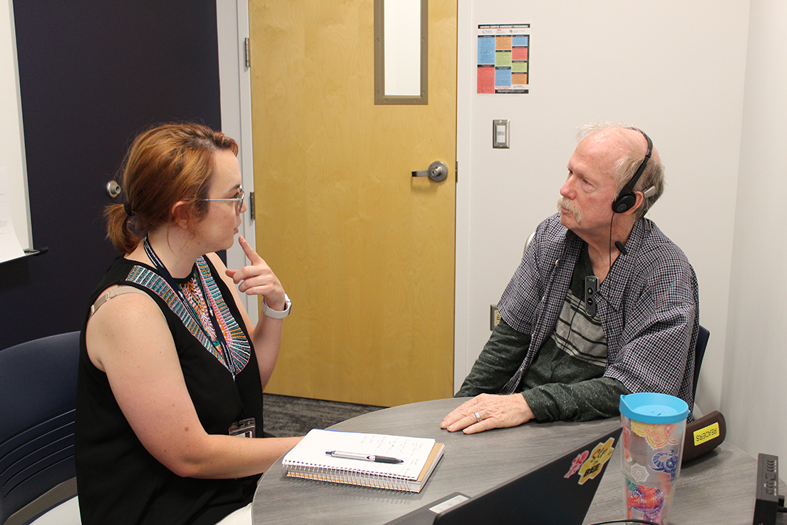 Graduate MS SLP student (left) working with an older adult (right)