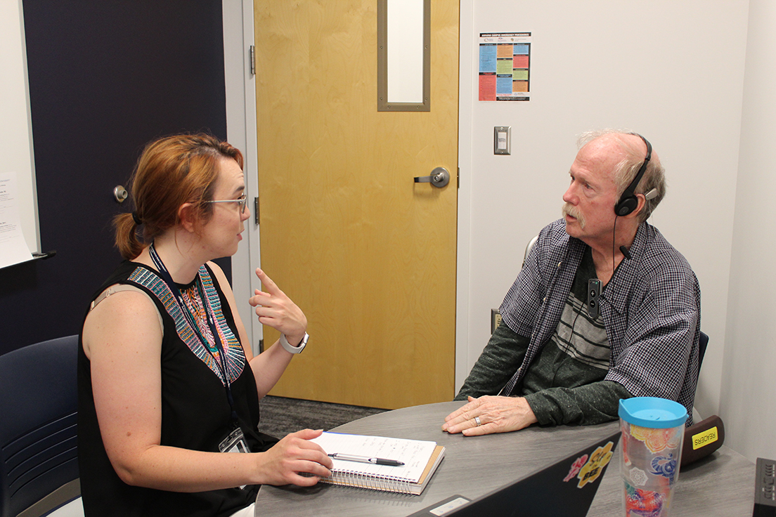 Graduate MS SLP student (left) working with an older adult (right)