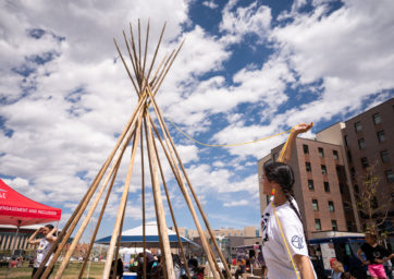 Auraria NISA Circle member helping set up tipi.