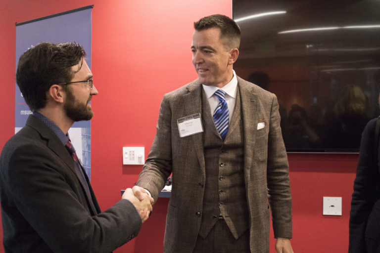 Matthew Current, MSU Denver business student, thanks Mariner Kemper, chairman and CEO of UMB Financial Corporation, for his support