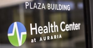 Vinyl on door that says PLAZA BUILDING and Health Center at Auraria with logo underneath.