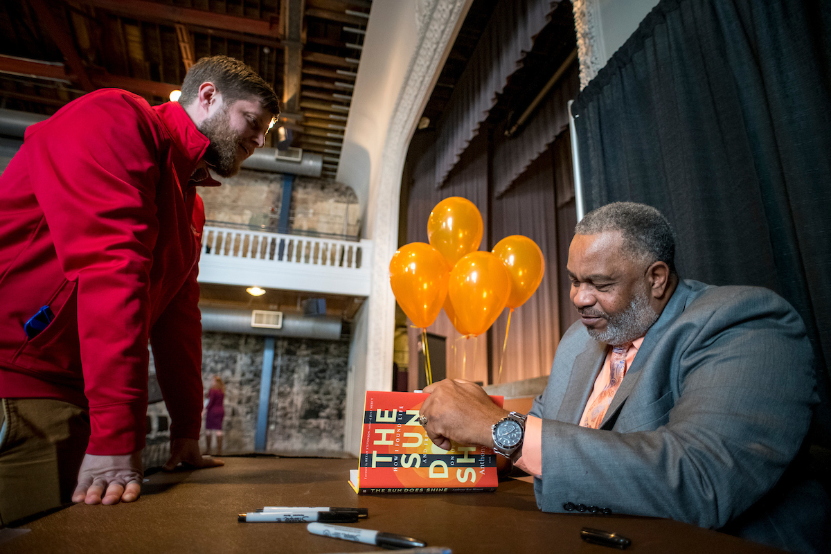 Anthony Ray Hinton signing his book with a student