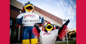 Rowdy the mascot stands in front of a large, inflatable Rowdy.