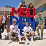 Students posing around MSU Denver sign outside JSSB