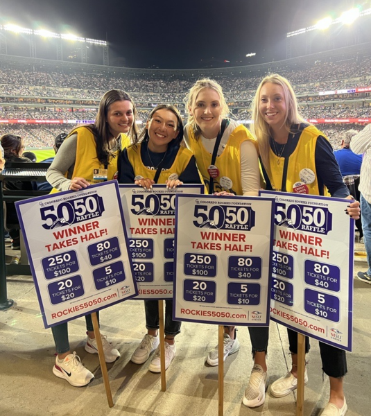 Four people working to sell raffle tickets