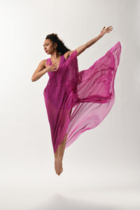 Justice Miles jumping with swirling pink dress