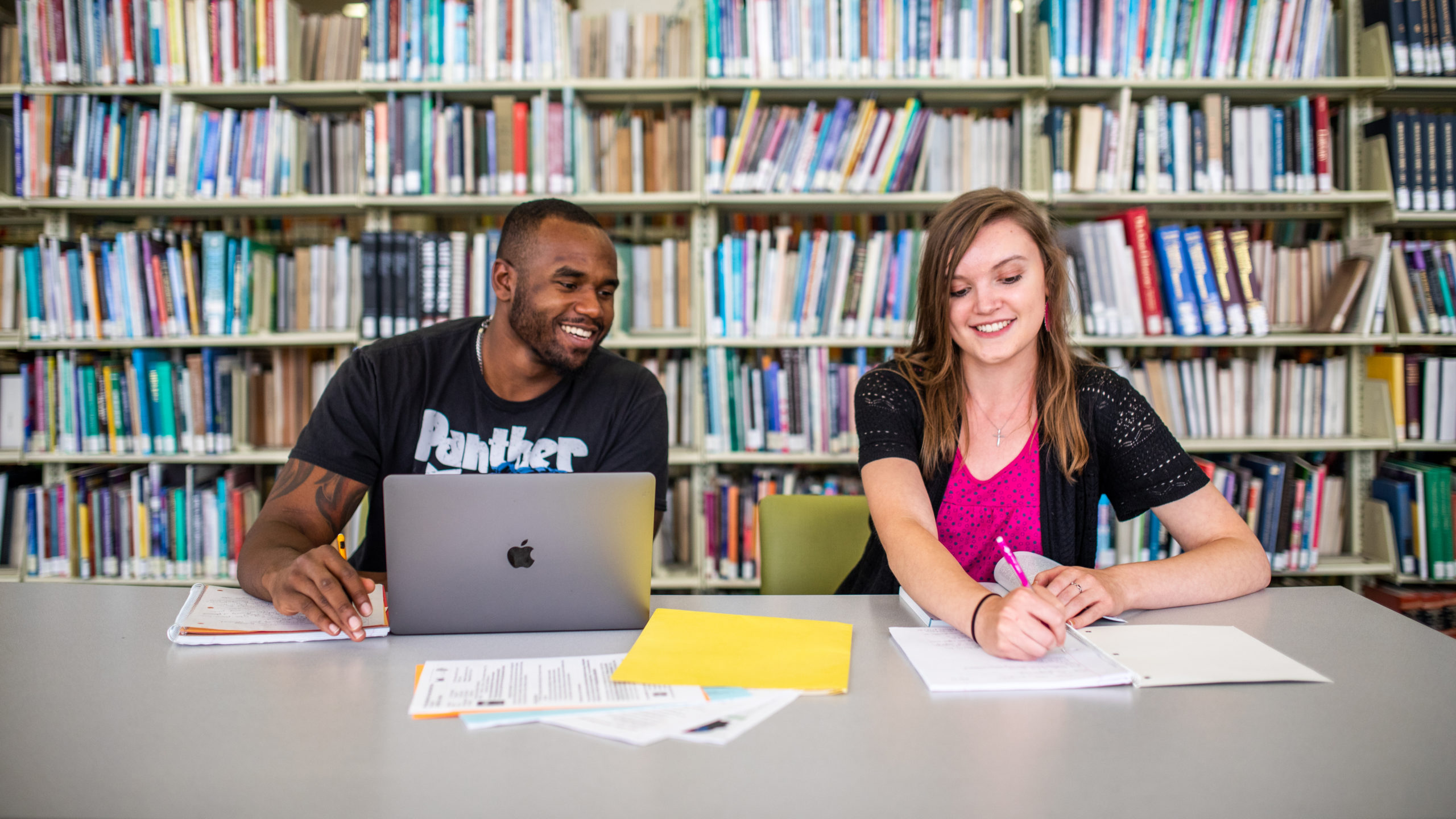 Two students studying in a library