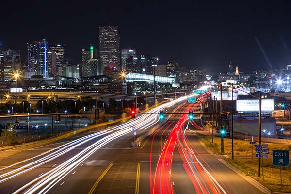 Downtown Denver at night during rush-hour traffic.