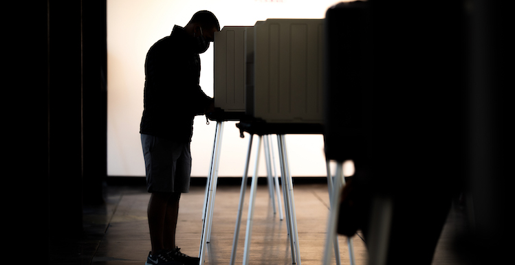 Silhouette of person voting
