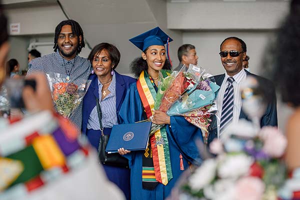 An MSU Denver graduate at Commencement with her family.