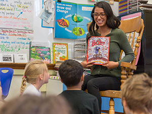 A preschool teacher reading to her class.