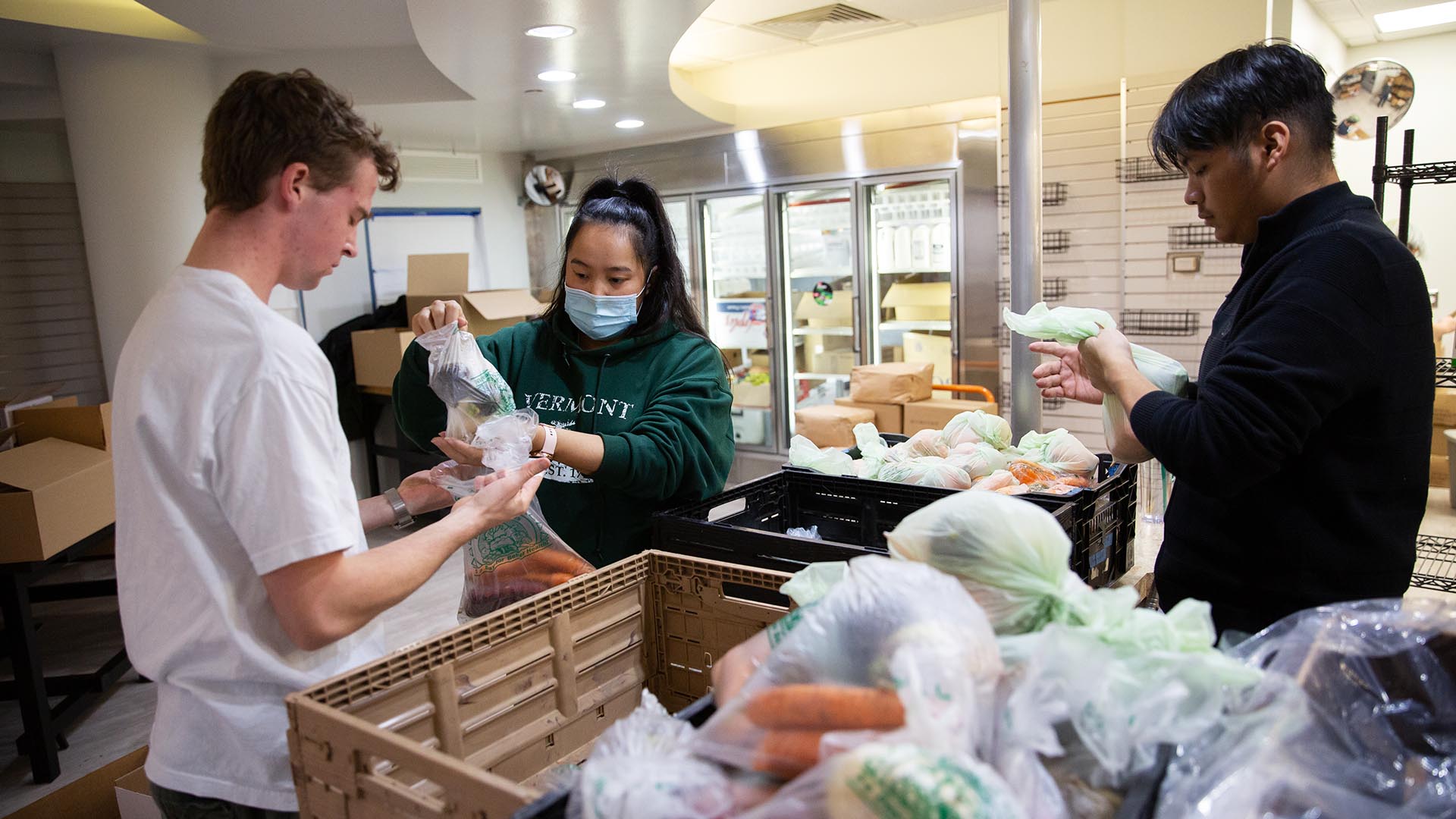 Food pantry student employee Hannah Hamilton and volunteers Wyatt Falborn (white t-shirt), Kolby Bautista and Abel Bautista (glasses) pack harvest boxes in Rowdy’s Corner, the new food pantry location in the Tivoli, on Wednesday, Nov. 16, 2022.