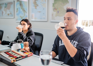 Two students tasting beers in a classroom