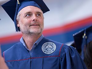 MSU Denver student in his cap and gown.