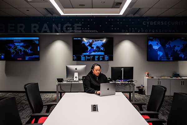 Student works on her laptop at the MSU Denver Cyber Range.