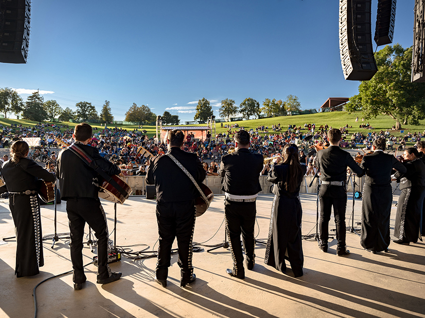 Mariachi group performing on outdoor stage