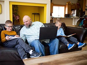 Father helping his kids with their homework.