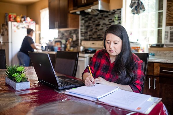 Student studying in the dining room.