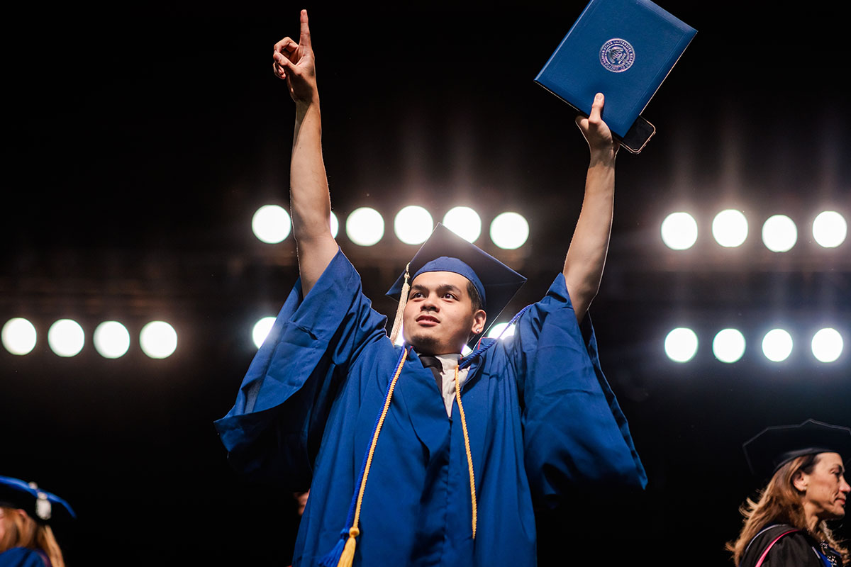 MSU Denver graduate proudly receives his diploma.