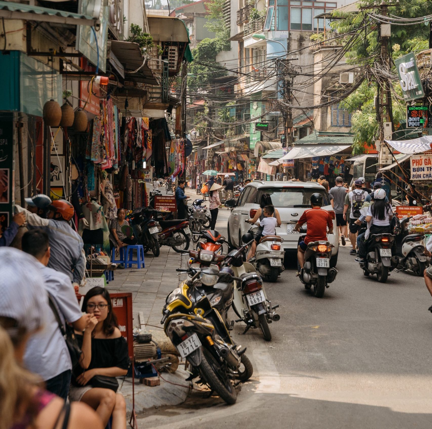 city street in Vietnam with motorbikes, restaurants, and housing