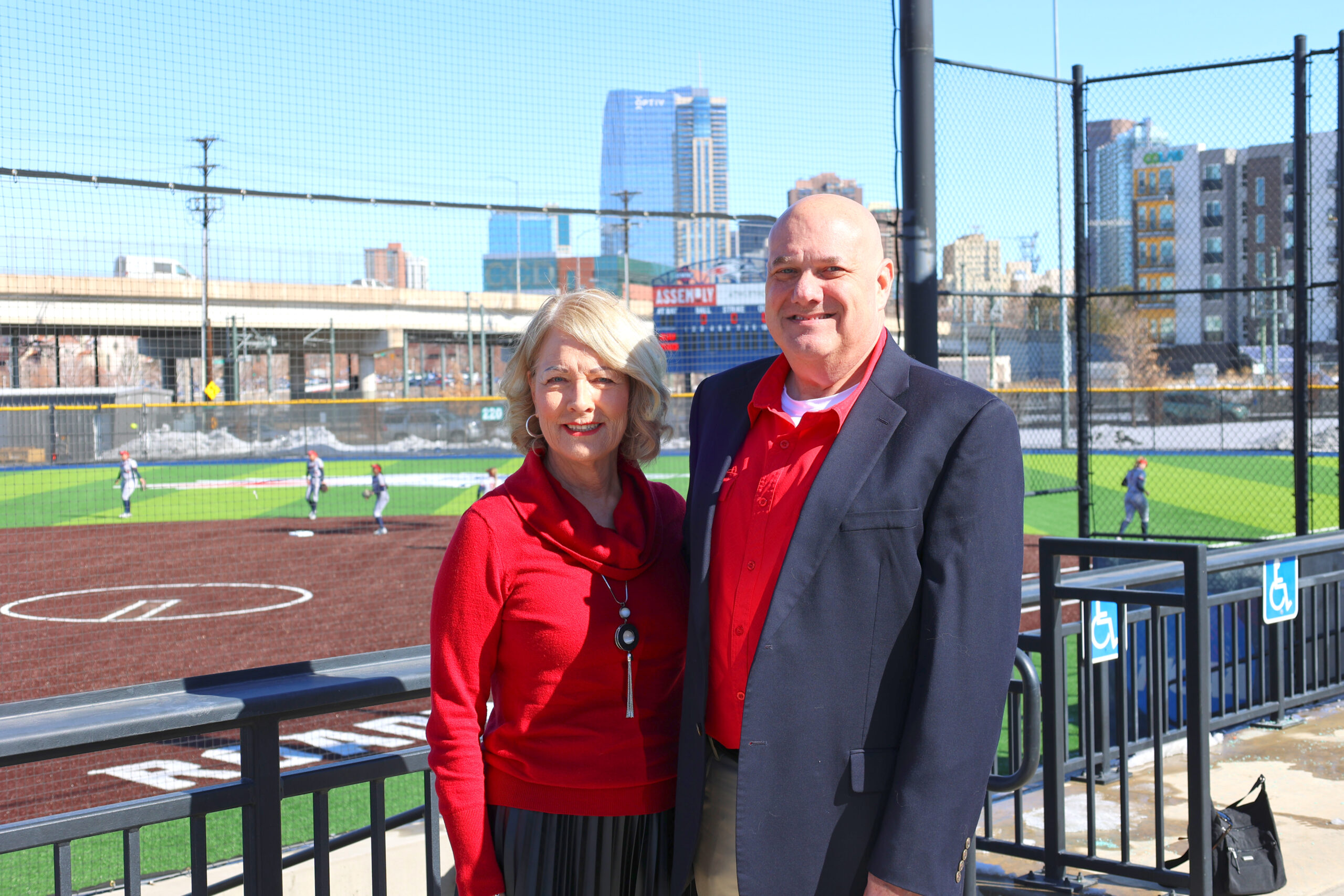 Judy and Brad Kaplan standing at the top of the stands at MSU Denver's softball stadium.