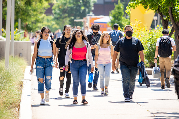 Students walking towards camera outside on Auraria campus during a sunny day