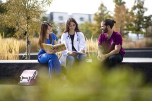three health profession students sitting outside on auraria campus