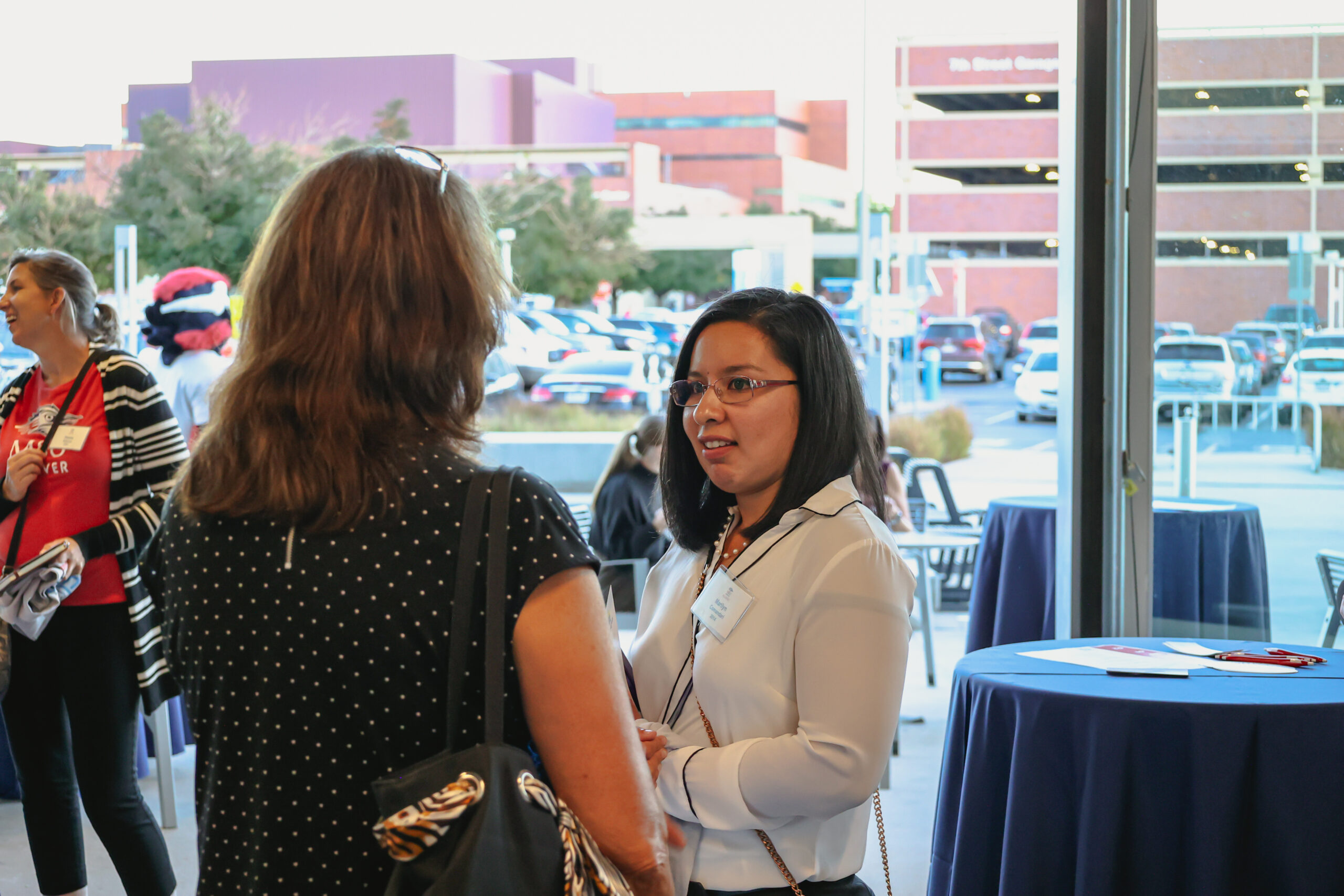 Two people talking at the 2022 Women of MSU Denver event during Homecoming Week.